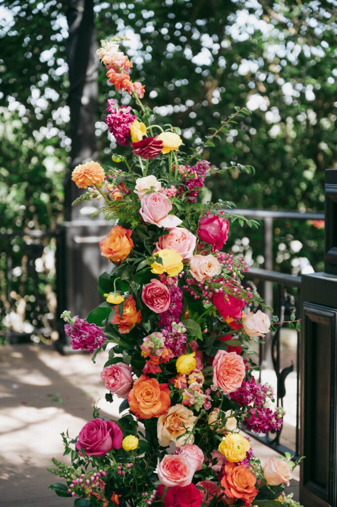 colorful wedding ceremony arch florals on film