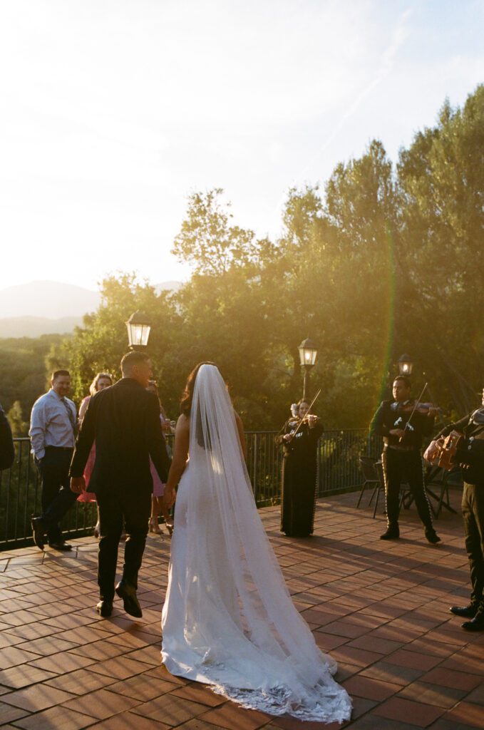 newlyweds walking on terrace at sunset captured on film