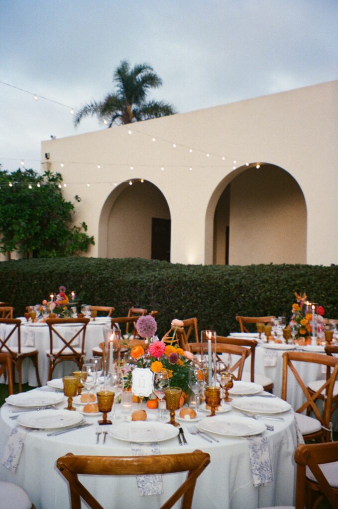 Elegant outdoor wedding reception setup with string lights in San Diego