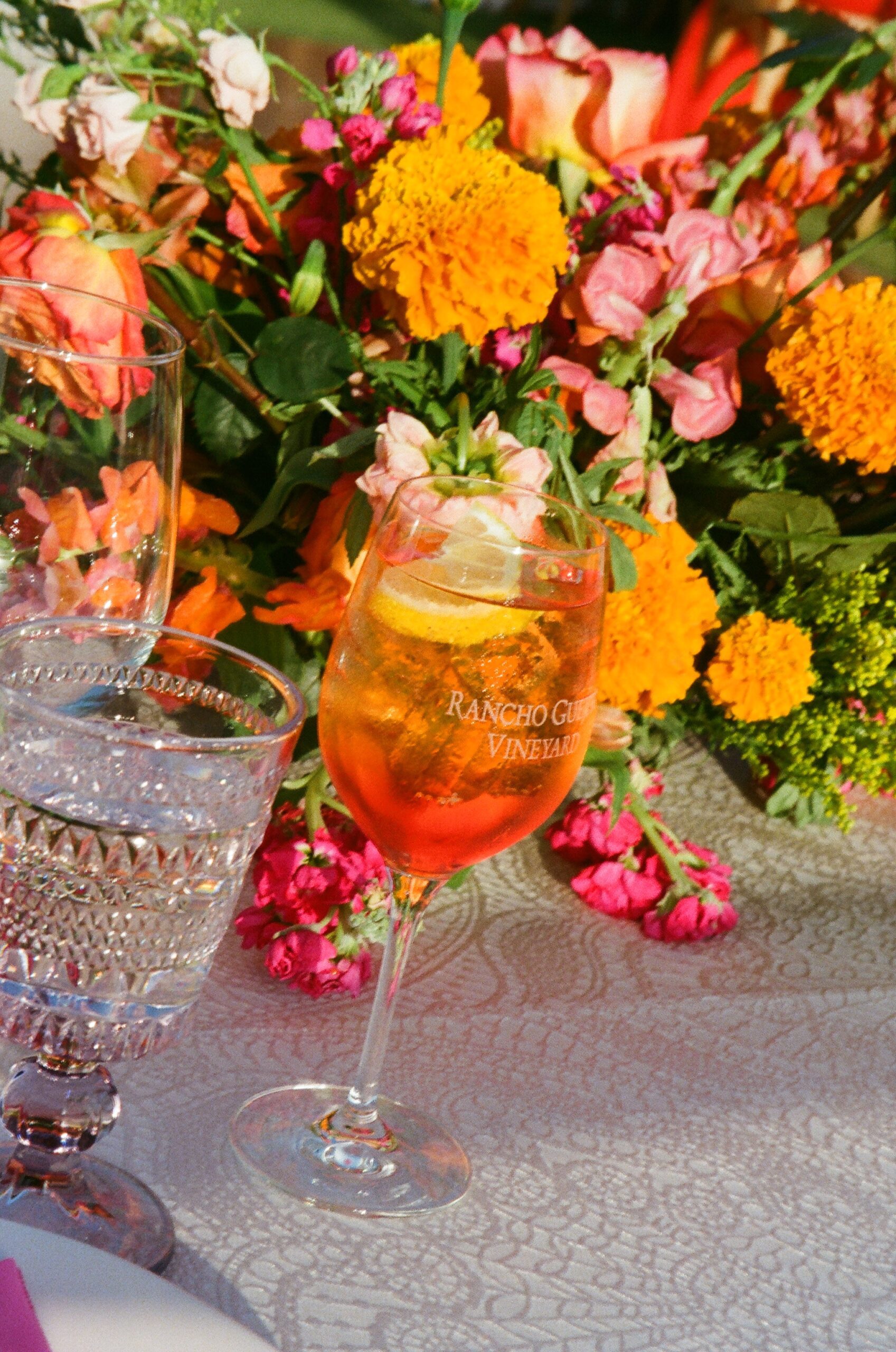 Aperol spritz with marigold centerpiece at San Diego outdoor reception