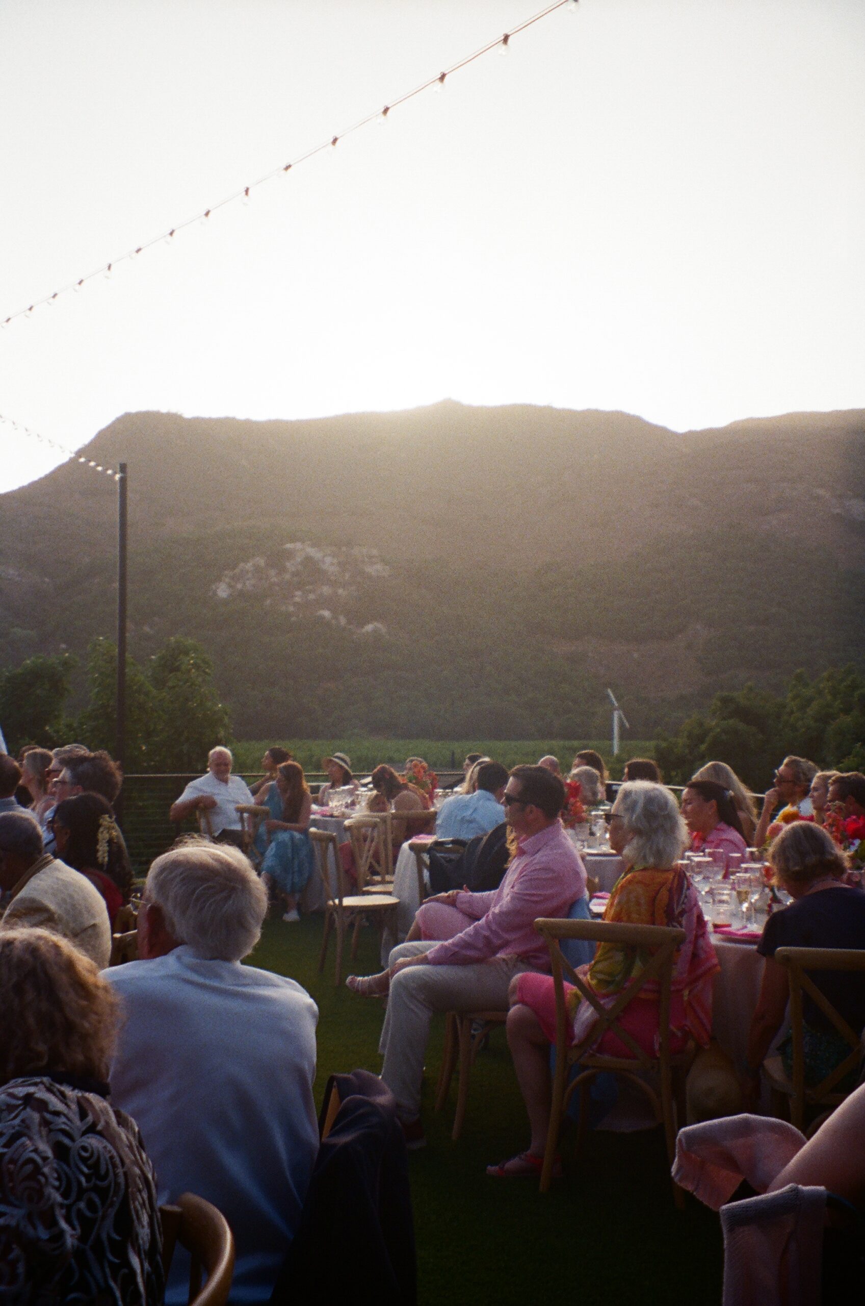 Guests enjoying outdoor wedding dinner with mountain views in San Diego