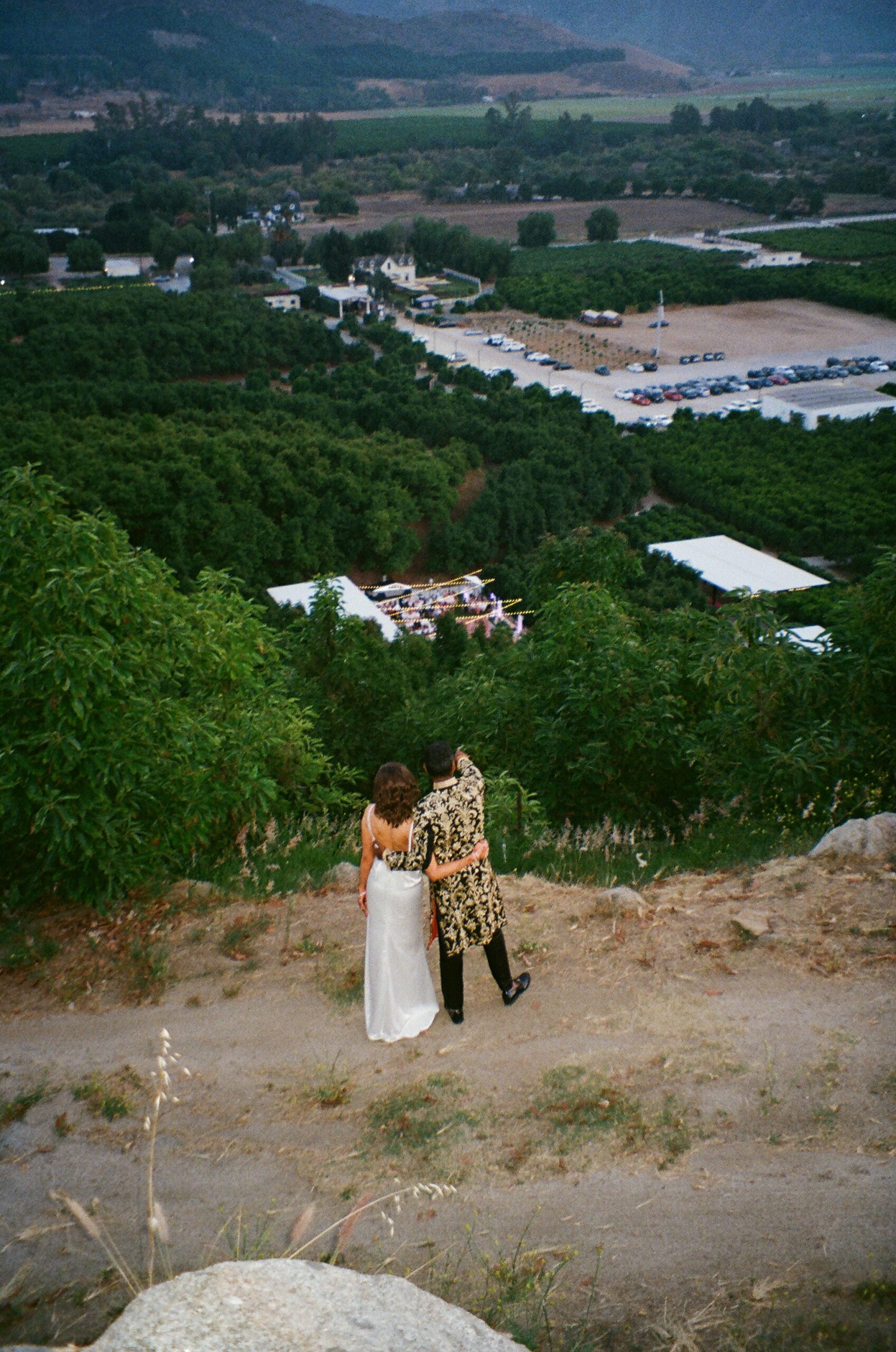 Couple overlooking vineyard wedding venue in San Diego hills
