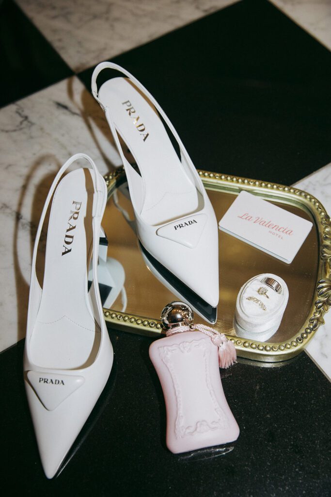la valencia wedding details including Prada shoes, perfume, and the wedding rings 